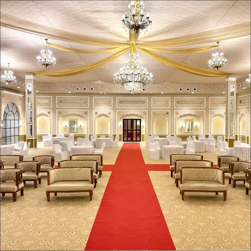 Banquet hall set with rows of seating facing the stage
