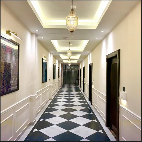 Guest corridor with pendant lights and a chequered floor