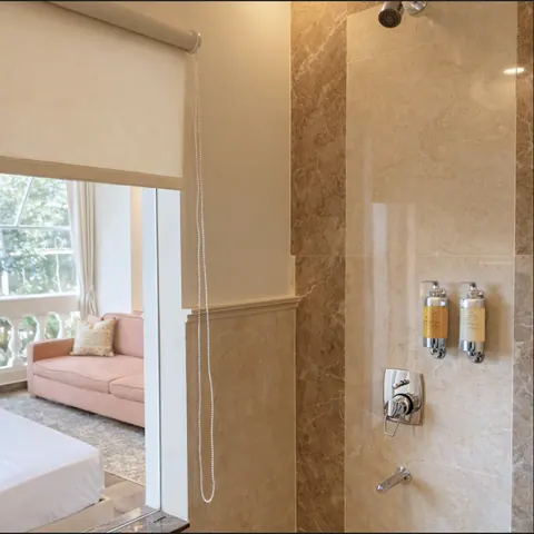 Imperial Family Suite walk-in shower in travertine