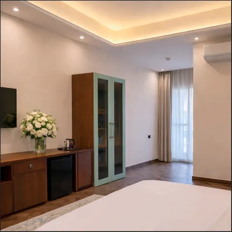 Premium King Room showing the wardrobe, desk and balcony door