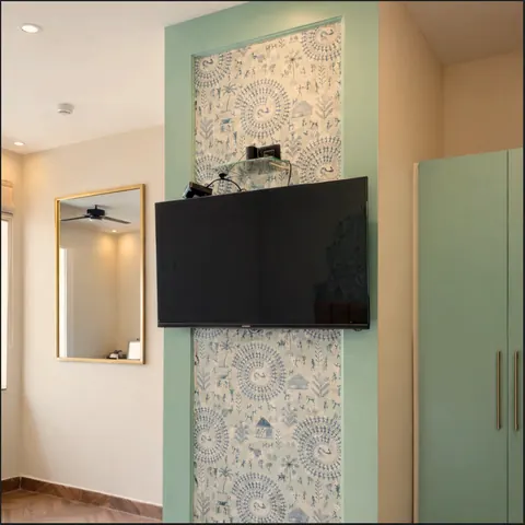 Standard Room with block-print feature panel, wall-mounted TV and wardrobe