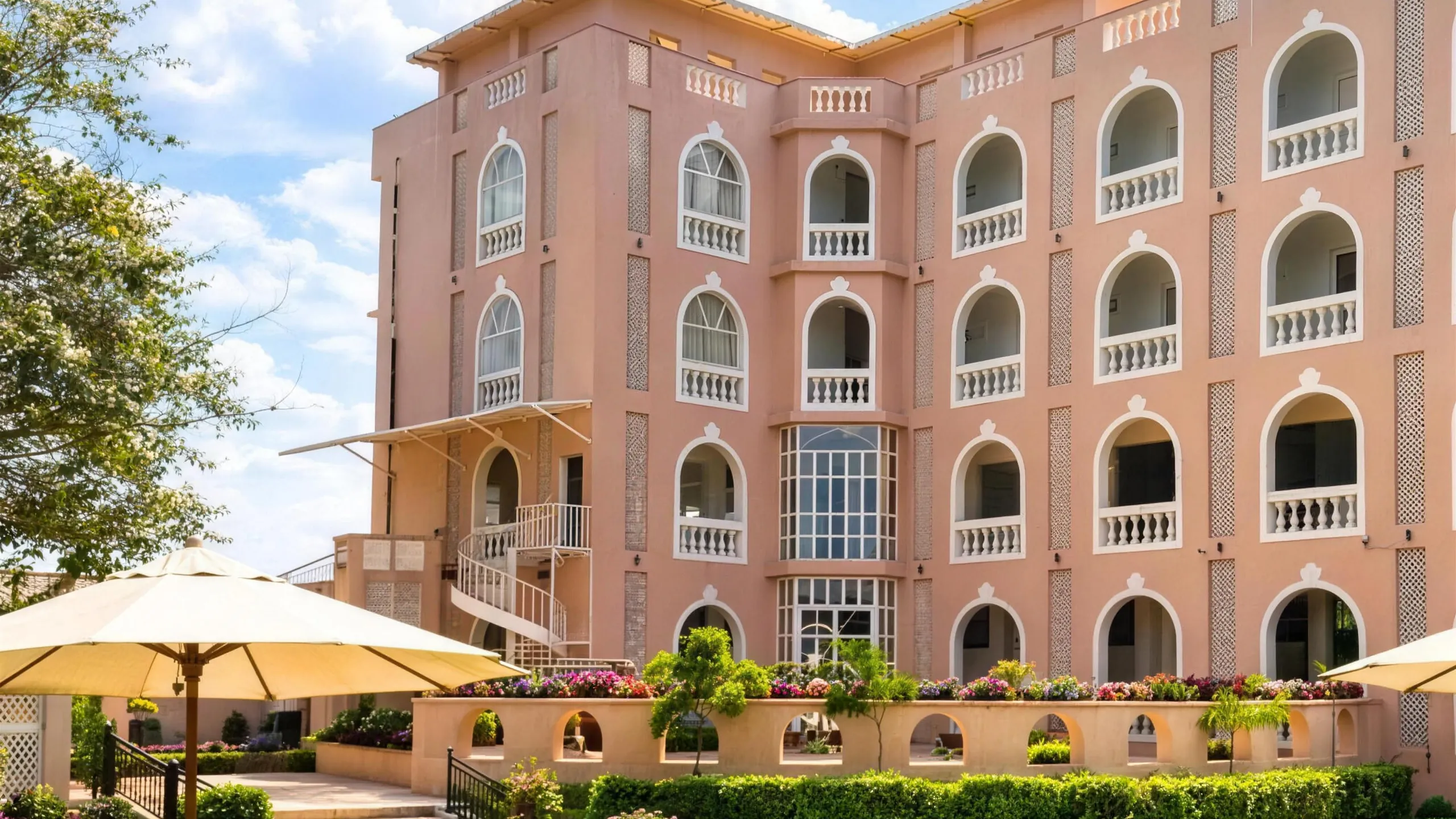 The Rambagh Resort palace facade above the garden lawn